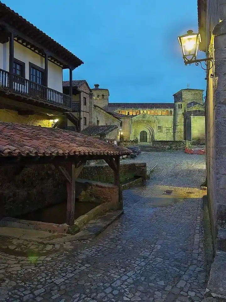 Colegiata de Santa Juliana iluminada desde la Calle del Río, uno de los principales lugares que ver en Santillana del Mar.